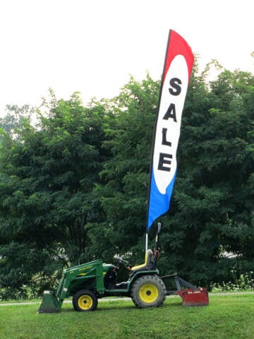 Garage sale sign mounted to a tractor.