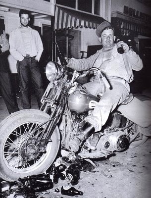 man riding vintage motorcycle