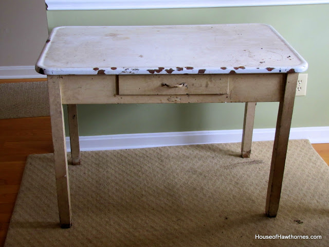 A vintage enamel top table doubles as a potting table or bench.