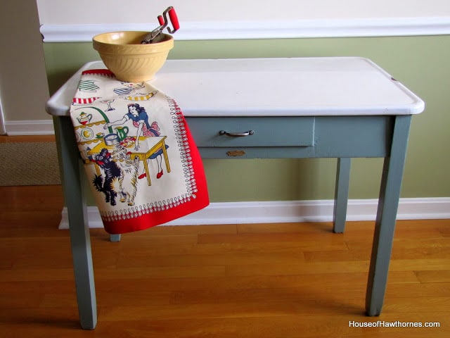 A vintage enamel top table doubles as a potting table or bench.