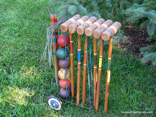 Vintage croquet set on a metal rack.