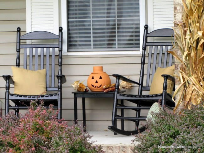 Fun fall front porch decor using traditional cornstalks, Indian corn, gourds and mums along with the unexpected - a vintage toy truck loaded with pumpkins.