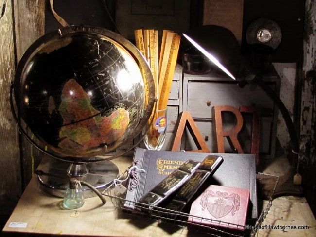 Globe with artist supplies in a vintage setting.