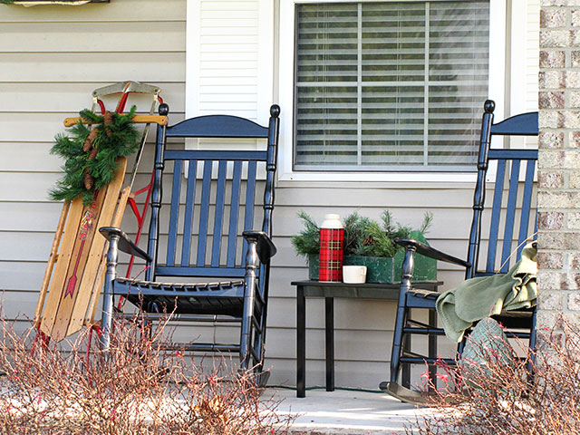 Black rockers on a winter porch.