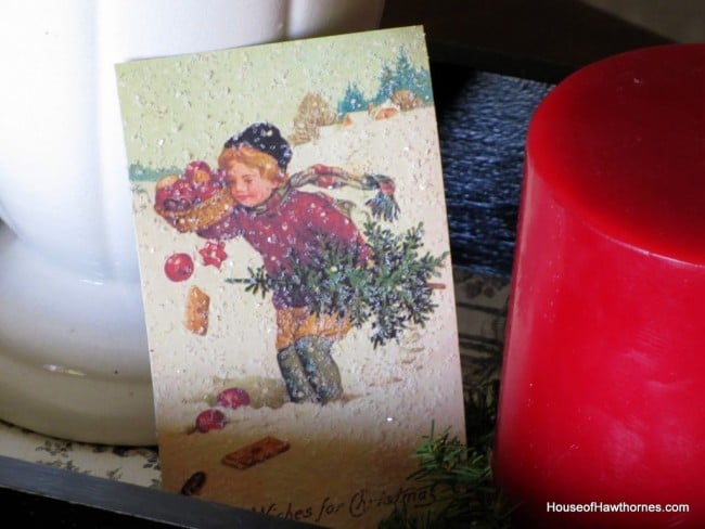 Vintage Christmas card image with a boy carrying a Christmas tree. 