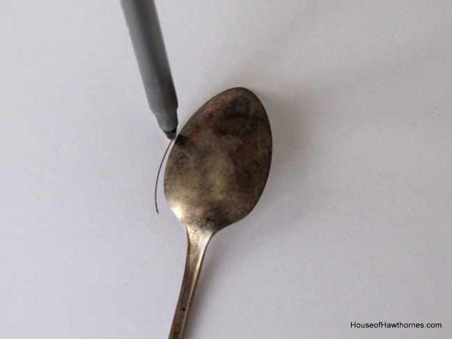 Using a teaspoon to make pattern for felt flowers.
