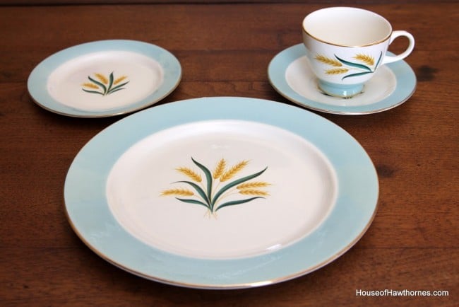 4 piece place setting from a vintage set of Viking golden wheat patterned dinnerware. Aqua coloring on the rims and a golden wheat pattern in the middle of the china.