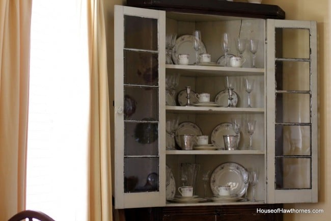 Corner cupboard with doors open.