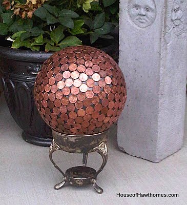 Penny bowling ball setting on a silver chafing dish holder.