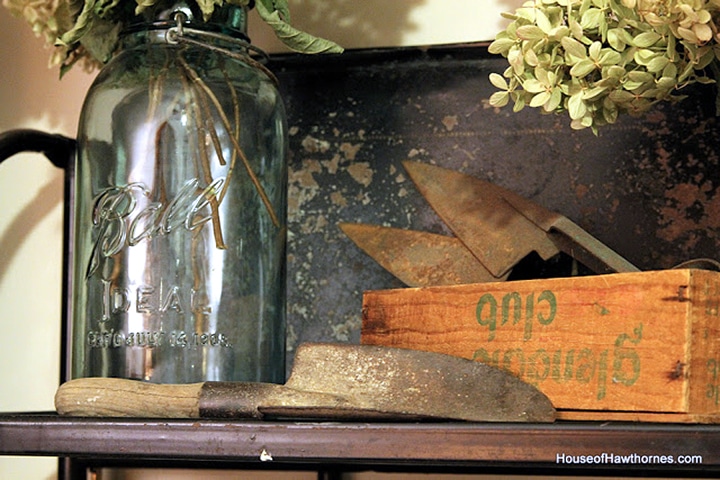 Blue mason jar setting on a shelf.