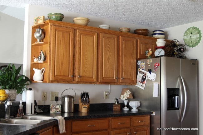 Kitchen cabinets with vintage mixing bowls above.