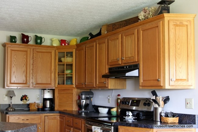 Kitchen cabinets with vintage Fiestaware pitchers above.
