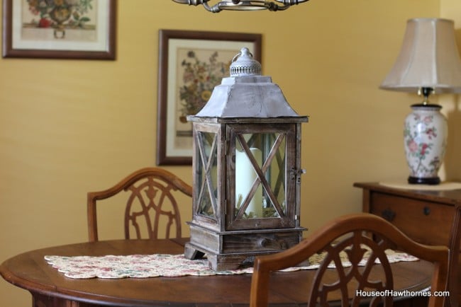 Wooden lantern with candle inside.