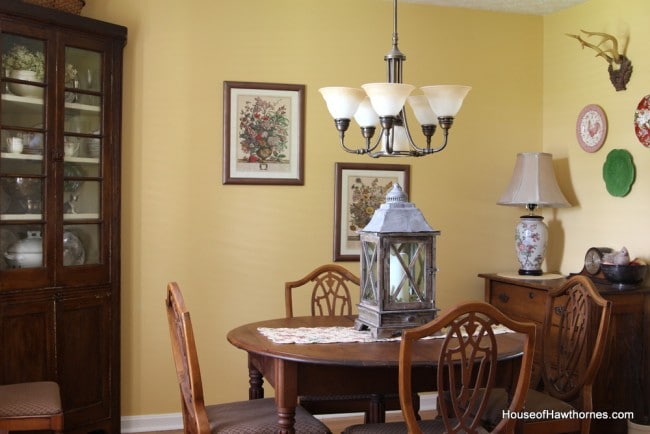 Dining room with yellow walls and decorated in vintage decor.