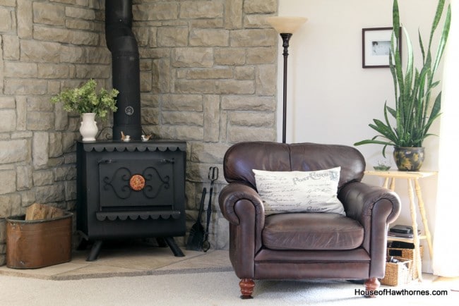 Brown leather armchair and wood stove.
