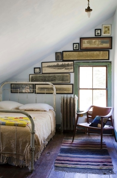 Gallery wall in a bedroom using antique yard long photos. 