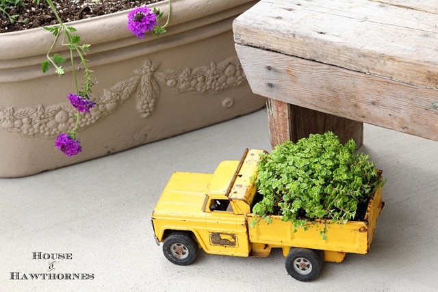 What a fun gardening DIY project! Upcycle a toy truck into a planter (this rusty one was found at a yard sale). Too cute!