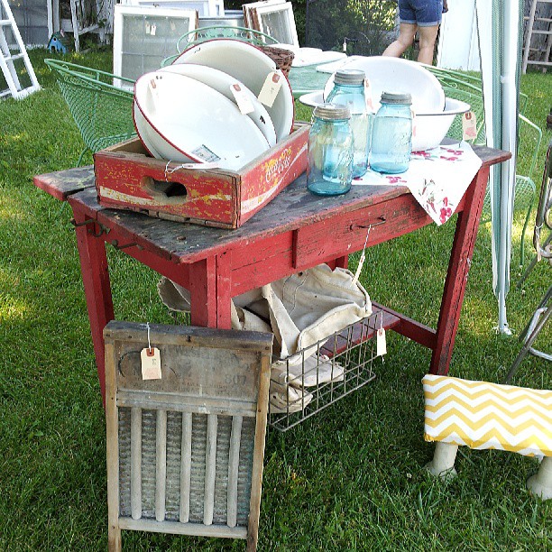 Rustic red farm table with vintage Coca-cola crate, Ball mason jars and a wooden washboard.