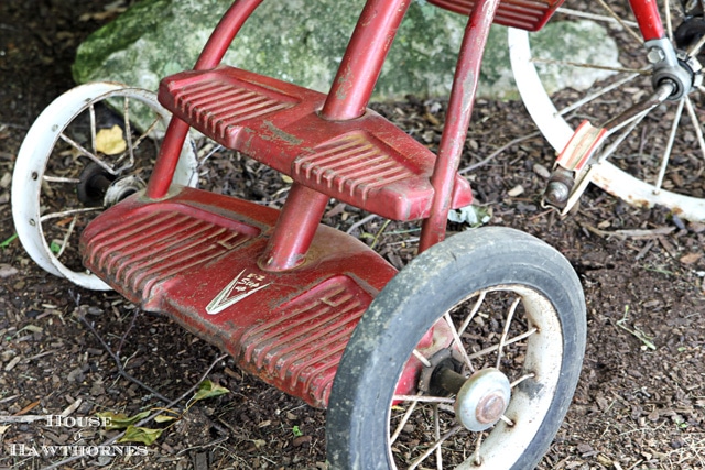 Double-decker platform on back of a vintage Murray tricycle.