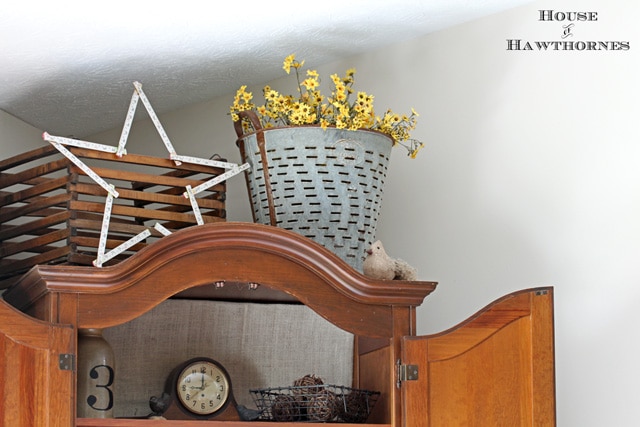 Olive bucket on top of a cabinet for a farmhouse look.