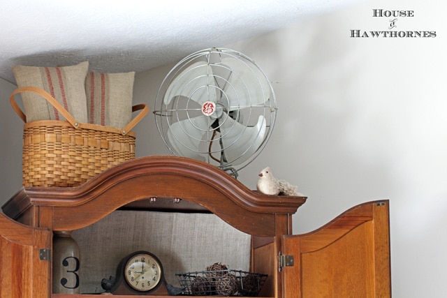 Vintage fan on top of a cabinet.
