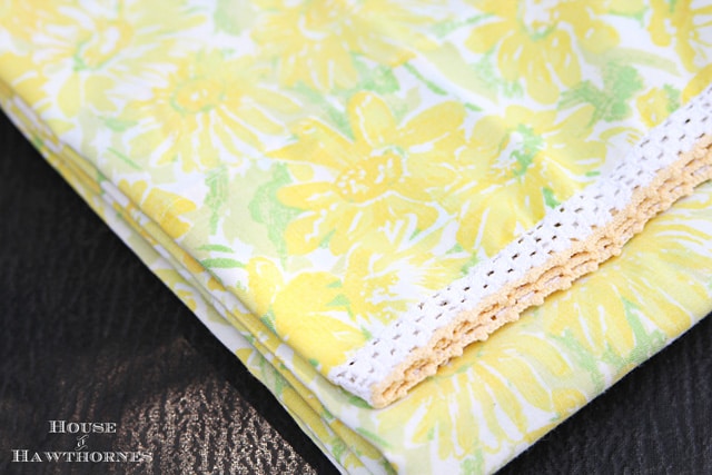 Vintage daisy pillowcase with crocheted trim.