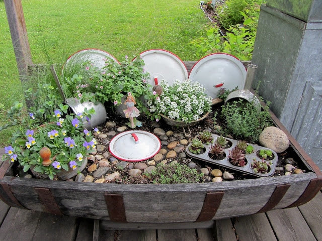 Fairy garden in a wine barrel from organizedclutter.net