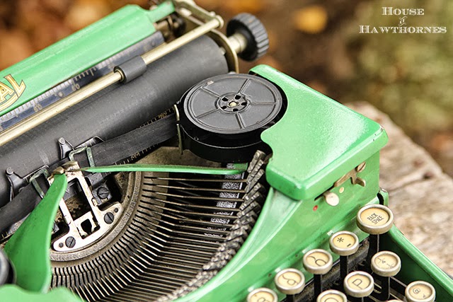 Vintage green typewriter with ribbon.