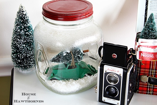 Car with Christmas tree tied to top in a snow jar