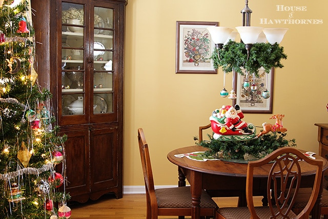 Fun vintage Christmas decor in the dining room including Shiny Brites and blow molds