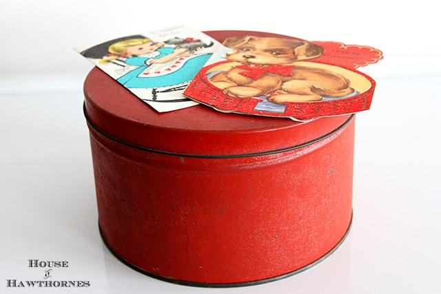 Rusty red tin with vintage Valentines.