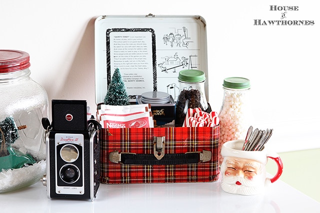 A vintage inspired hot cocoa station for the holidays. Cute ideas for a Christmas display! Love the old Santa mug, vintage camera and plaid school lunchbox! A vintage inspired hot cocoa station for the holidays. Cute ideas for a Christmas display! Love the old Santa mug, vintage camera and plaid school lunchbox!