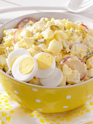 deli style potato salad with sliced eggs and radish