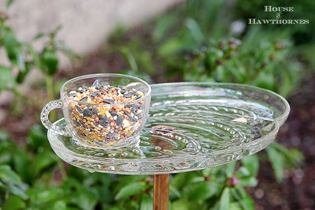 Vintage glass snack set repurposed into a bird feeder