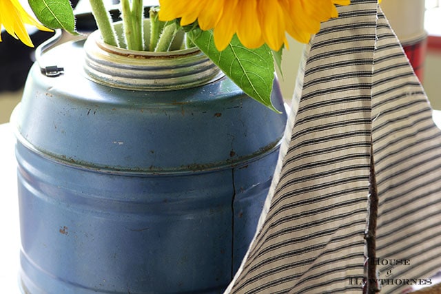 Sunflower vignette using vintage picnic jug, thermoses and twig sailboat Sunflower vignette using vintage picnic jug, thermoses and twig sailboat