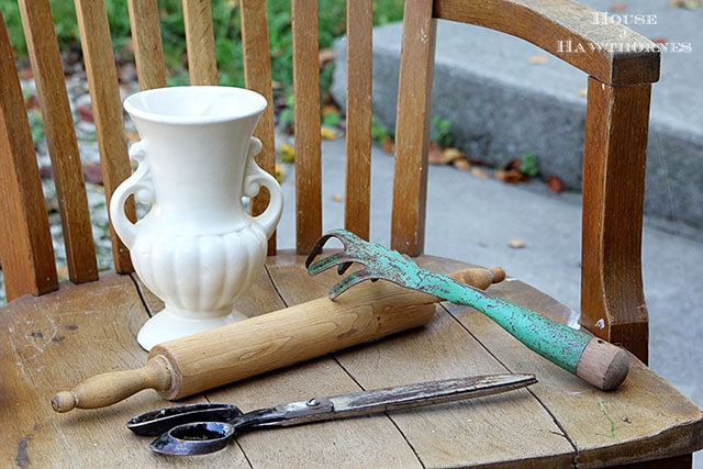 Yard sale finds including a McCoy vase, wooden rolling pin, huge scissors and vintage rusty hand rake