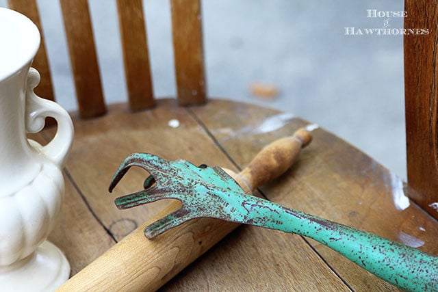 Vintage rusty hand garden rake in a fabulous green color