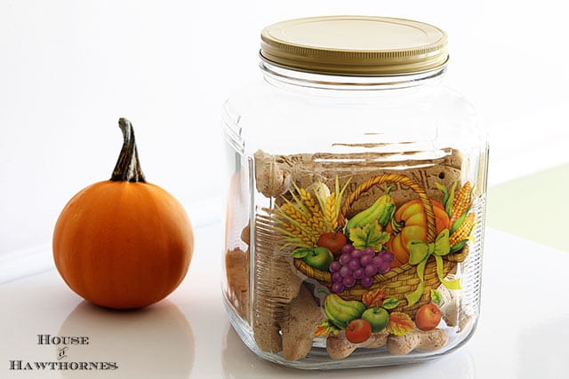 Take a plain Jane Anchor Hocking glass cracker jar and turn it into a vintage thing of beauty :) Anchor Hocking glass cracker jar with a window cling used as decoration.