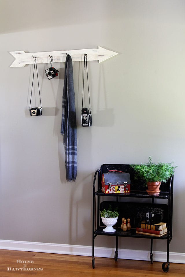 Hallway view of the Versa Fold n Roll table from the 1960's. Vintage cameras hanging on a coat hook on the wall. 