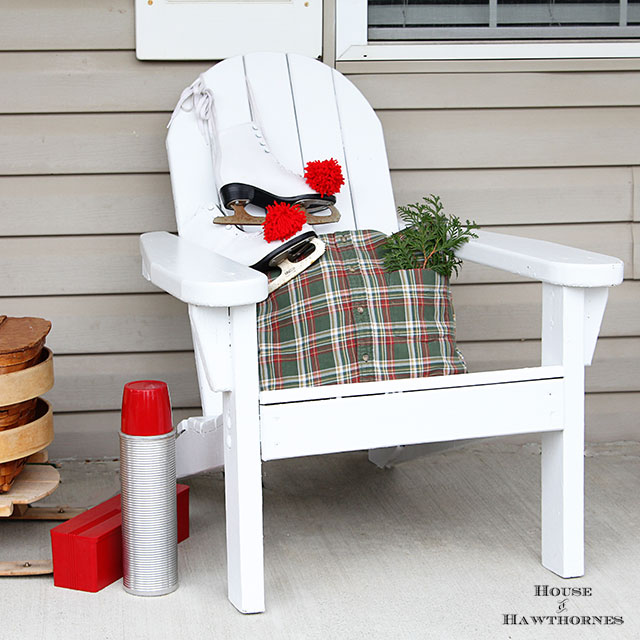 Fun holiday front porch ideas are shown, including chalk painted skis, vintage Thermoses and plaid decor for Christmas. And most of the items were found at thrift stores and estate sales.