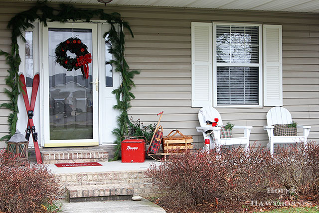 Fun holiday front porch ideas are shown, including chalk painted skis, vintage Thermoses and plaid decor for Christmas. And most of the items were found at thrift stores and estate sales.