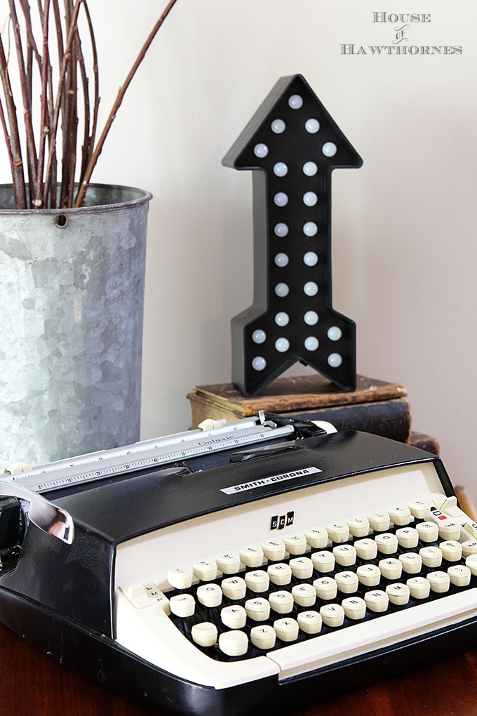 Vintage Smith Corona Galaxie typewriter as part of a rustic vintage eclectic style summer home decor tour including vintage thermoses, cameras, typewriter and vintage croquet and badminton equipment.