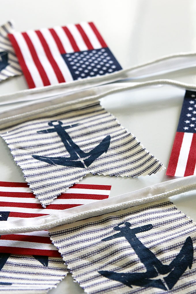 A super easy DIY patriotic banner tutorial. Anchors, flags and sailboats combine for a nautical Fourth Of July home decor style or any patriotic holiday.