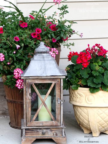 Summer porch decorating ideas and inspiration using farmhouse touches, vintage items, plenty of annual flowers and a healthy dose of patriotic decor.