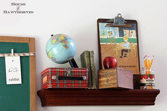 Back to school vignette with a vintage globe and plaid lunchbox