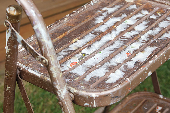 A yard sale makeover using spray paint to update a vintage step stool into a work of art. OK, that may be going a bit far, but it is a cute DIY project.