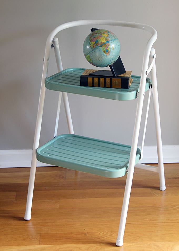 A yard sale makeover using spray paint to update a vintage step stool into a work of art. OK, that may be going a bit far, but it is a cute DIY project.