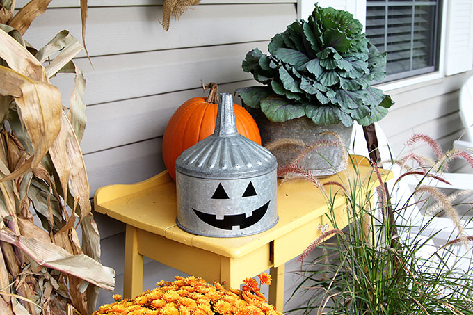 A super cute repurposed Jack-o-Lantern for Halloween made from a galvanized funnel. A quick and easy DIY project for fall!