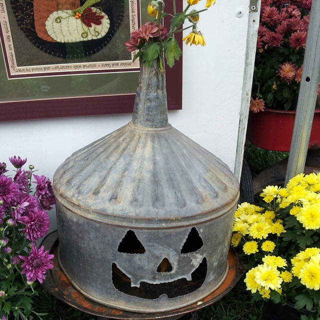 A super cute repurposed Jack-o'-Lantern for Halloween made from a galvanized funnel. A quick and easy DIY project for fall!