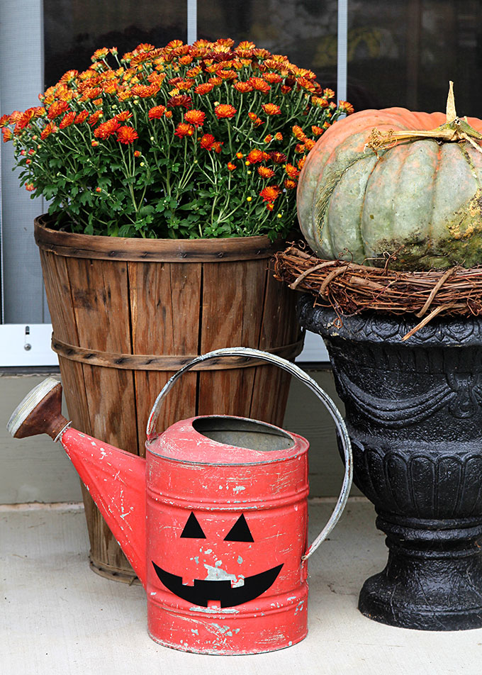 A super cute repurposed Jack-o-Lantern for Halloween made from a galvanized funnel. A quick and easy DIY project for fall!